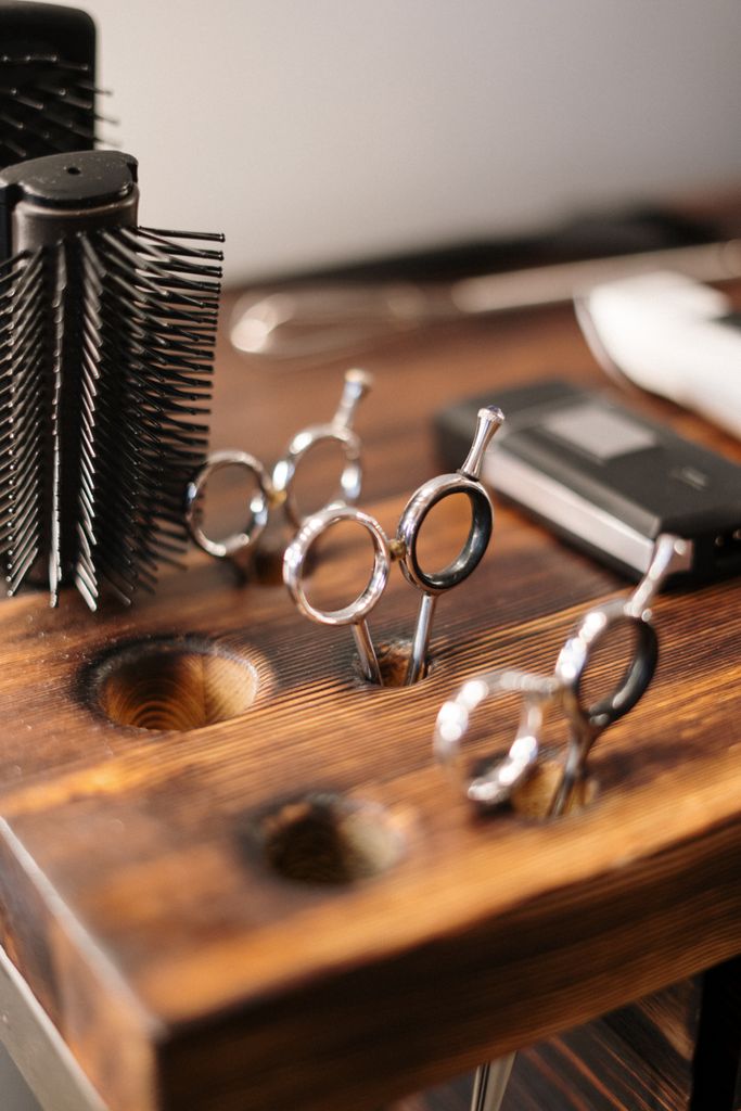 Professional hairdressing tools arranged on a salon table.
